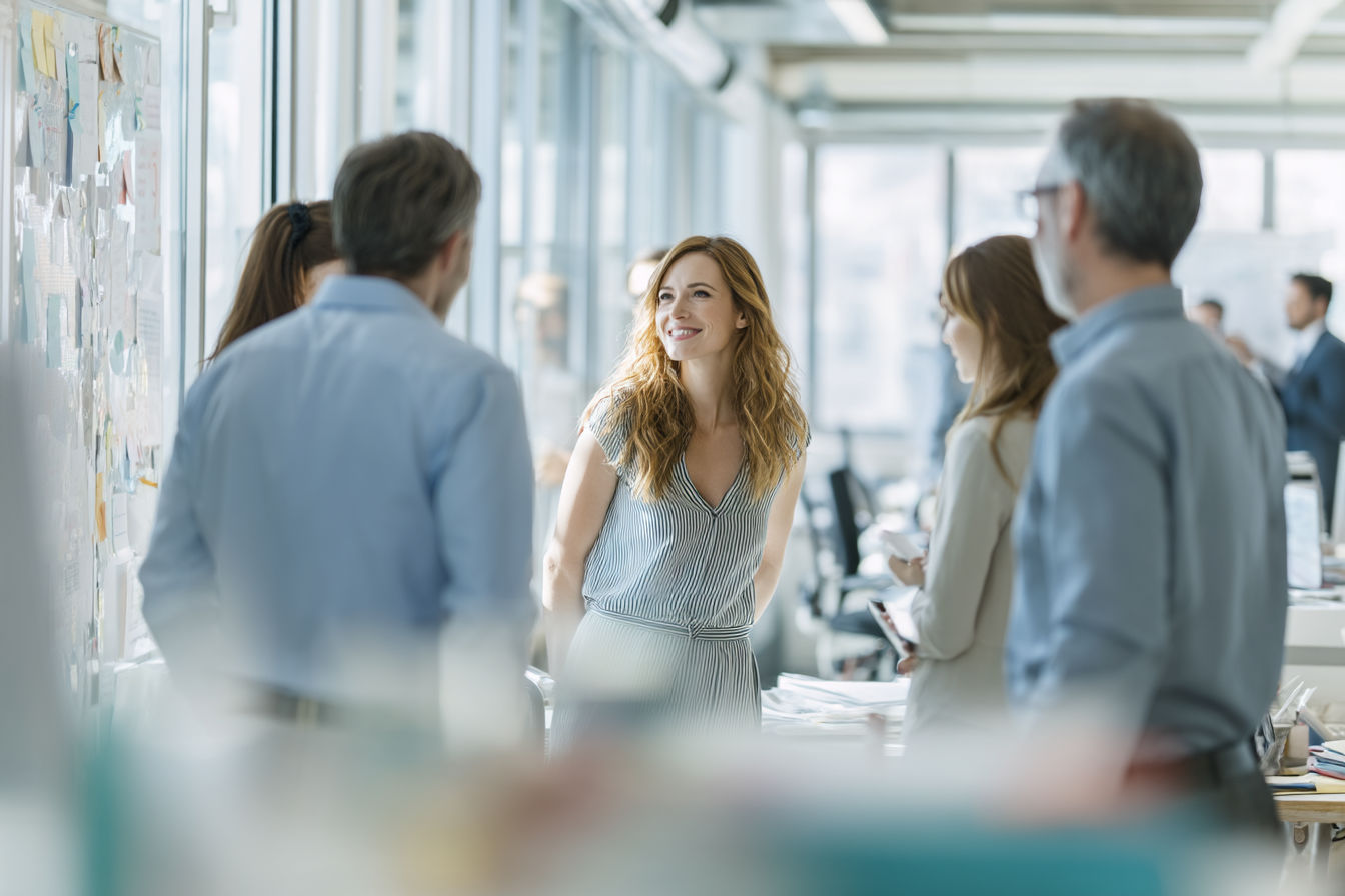 Professional workplace setting with diverse team members engaged in clear communication, using visual aids and active listening in a modern office environment. Clean, well-lit composition with subtle visual elements representing clarity and understanding.