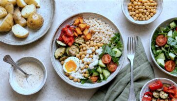 Healthy meal bowl with brown rice, chickpeas, egg, roasted vegetables and fresh salad.