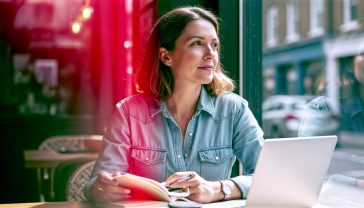 A hyper-realistic, professional photograph in the style of a modern lifestyle magazine. The image features a thoughtful person in their late 30s, sitting in a bright, contemporary British café with a laptop and a notebook. They are looking out of the window with a look of calm focus and clarity. The composition is a medium close-up, with soft, natural morning light creating a warm and optimistic mood. The background is slightly blurred, showing subtle hints of a typical British high street. The overall feel is inspiring, intelligent, and accessible, representing the idea of gaining mental clarity.
