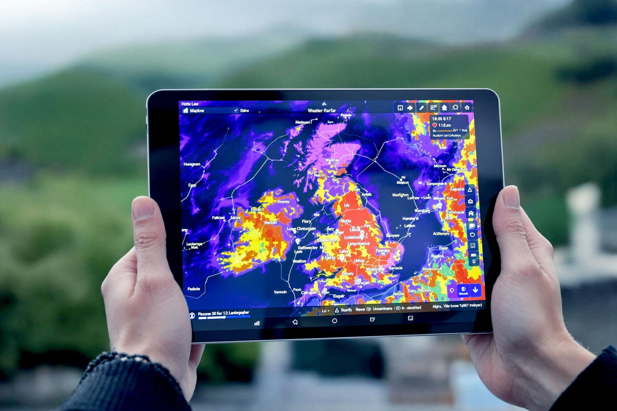 A high-angle, lifelike professional photograph of an iPad displaying a vibrant, animated weather radar map. The iPad is held by a person with a subtle background suggesting a UK outdoor setting (e.g., a misty coastline, a rolling green hill, or a city skyline). The image should convey a sense of preparedness and modern technology, with soft, natural lighting and a slightly shallow depth of field to keep the iPad and its screen as the focal point.