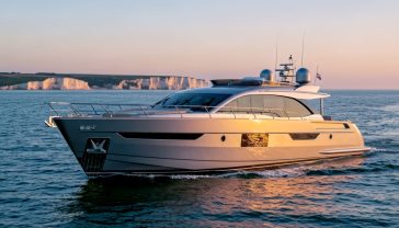A hyper-realistic, professional photograph in the style of a high-end marine lifestyle magazine. The scene captures a brand new, sleek 80-foot Sunseeker motor yacht cutting cleanly through the calm waters of The Solent, with the iconic chalk cliffs of the Isle of Wight softly focused in the background. The lighting is the magical 'golden hour' just before sunset, casting a warm, luxurious glow across the yacht's metallic grey hull and polished teak decking. The composition is a dynamic three-quarter bow shot, showing the vessel's power and elegance. The mood is one of aspiration, modern British luxury, and maritime heritage.