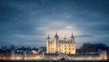 A hyper-realistic, professional photograph in the style of a National Geographic feature. The shot captures the iconic White Tower of London at dusk, viewed from across the River Thames. The ancient stone walls are bathed in warm, dramatic lighting against a softly blurred background, creating a powerful contrast between old and new. The mood is one of timelessness, grandeur, and deep historical significance, with a classic, grey-blue British sky overhead.